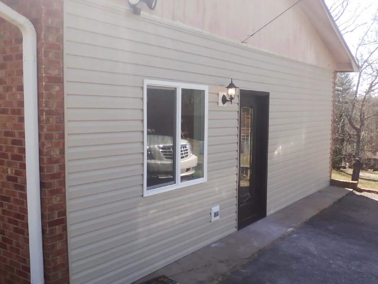 New vinyl siding and entry door on a room addition in Wilmerding
